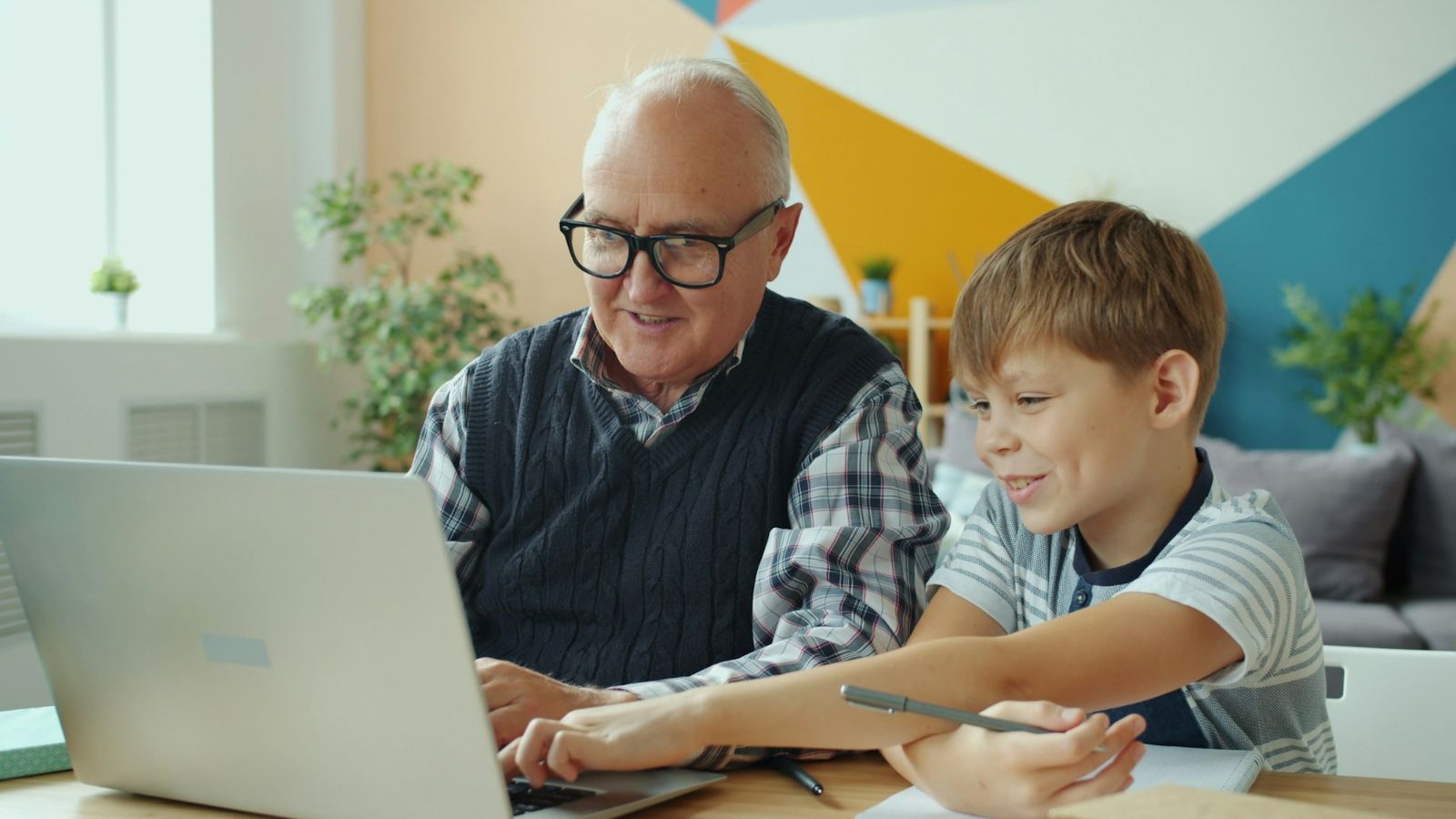 A grandfather and grandson at a laptop